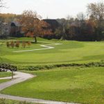 Panoramic view of a lush green golf course at West Chase Golf Club. Smooth