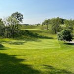 Panoramic view of a lush green golf course at Westminster National Golf Course. Smooth