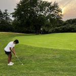 green grass with the flag in the hole.