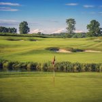 green grass with the flag in the hole.