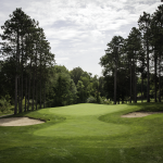 Panoramic view of a lush green golf course at Whispering Pines Golf Club & Banquet Hall. Smooth