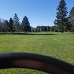 Panoramic view of a lush green golf course at White Birch Golf Course & Restaurant. Smooth