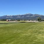 Panoramic view of a lush green golf course at White Pine County Golf Course. Smooth