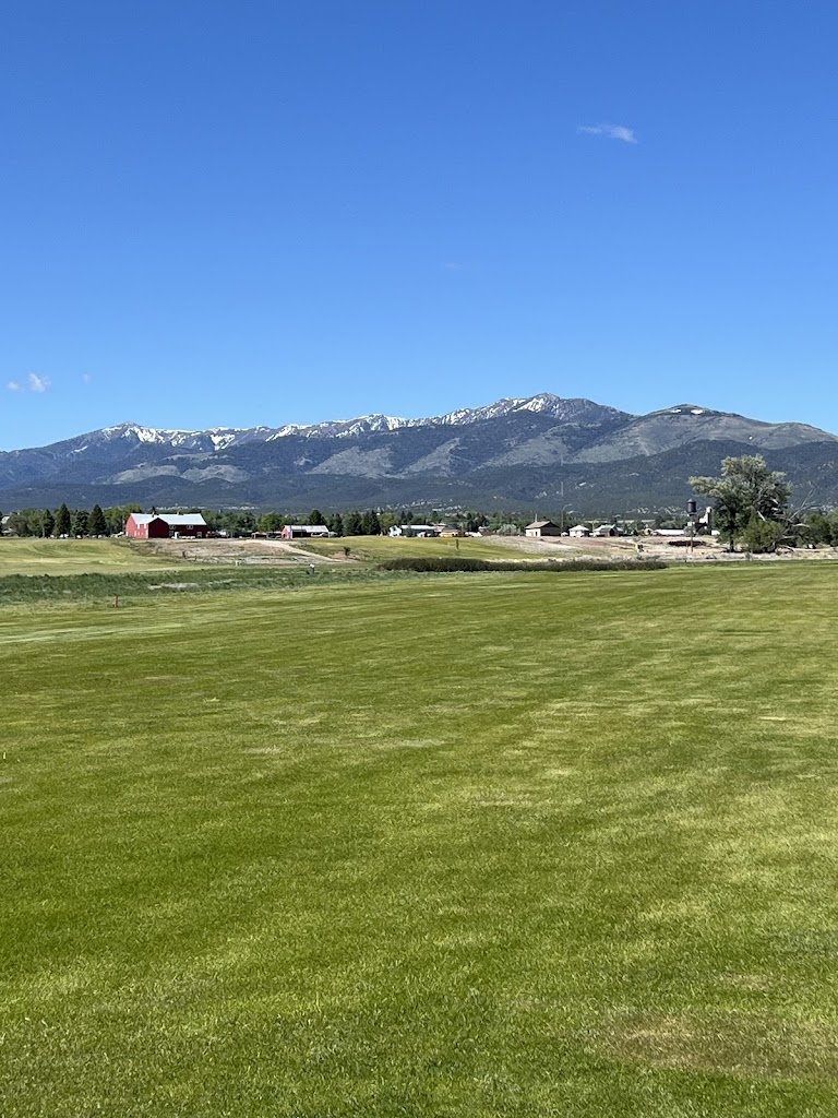 Panoramic view of a lush green golf course at White Pine County Golf Course. Smooth