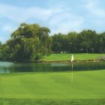 Panoramic view of a lush green golf course at White Pines Golf Club. Smooth