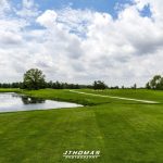 Panoramic view of a lush green golf course at White Pines Golf Course. Smooth