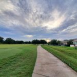 Panoramic view of a lush green golf course at White Wing Golf Club. Smooth