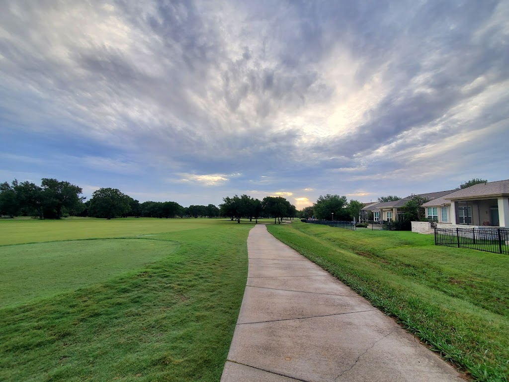 Panoramic view of a lush green golf course at White Wing Golf Club. Smooth