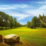 Panoramic view of a lush green golf course at Whitefish Golf Club. Smooth