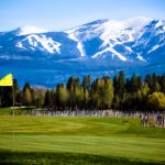 Panoramic view of a lush green golf course at Whitefish Lake Golf Club. Smooth