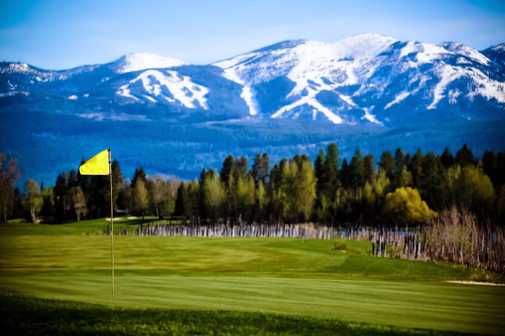 Panoramic view of a lush green golf course at Whitefish Lake Golf Club. Smooth