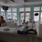 Panoramic view of a lush green golf course at Wild Dunes Harbor Golf Course. Smooth