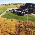 Panoramic view of a lush green golf course at Wild Horse Golf Club. Smooth