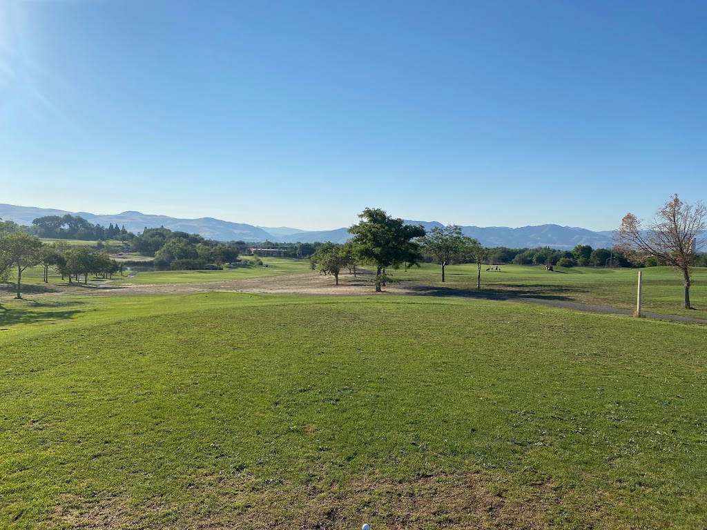 Panoramic view of a lush green golf course at Wildcreek Golf Course. Smooth