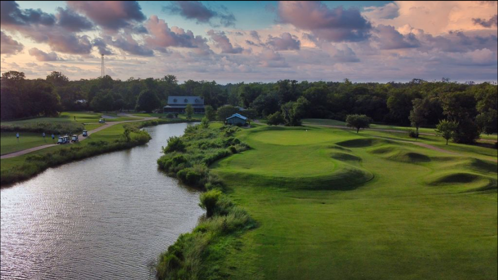 Panoramic view of a lush green golf course at Wilderness Golf Course. Smooth