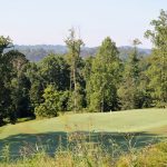 Panoramic view of a lush green golf course at Williams Creek Golf Course. Smooth