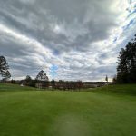 Panoramic view of a lush green golf course at Willow Hollow Golf Course. Smooth