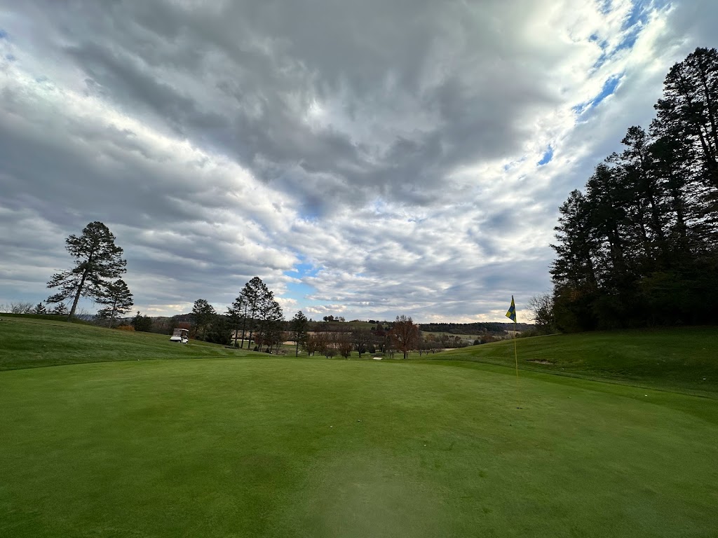 Panoramic view of a lush green golf course at Willow Hollow Golf Course. Smooth