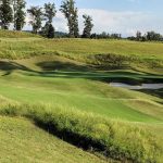 Panoramic view of a lush green golf course at WindRiver Golf Club. Smooth