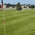 green grass with the flag in the hole.