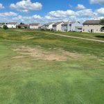 Panoramic view of a lush green golf course at Winding Ridge Golf Club. Smooth