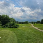 Panoramic view of a lush green golf course at Winding River Golf Course. Smooth