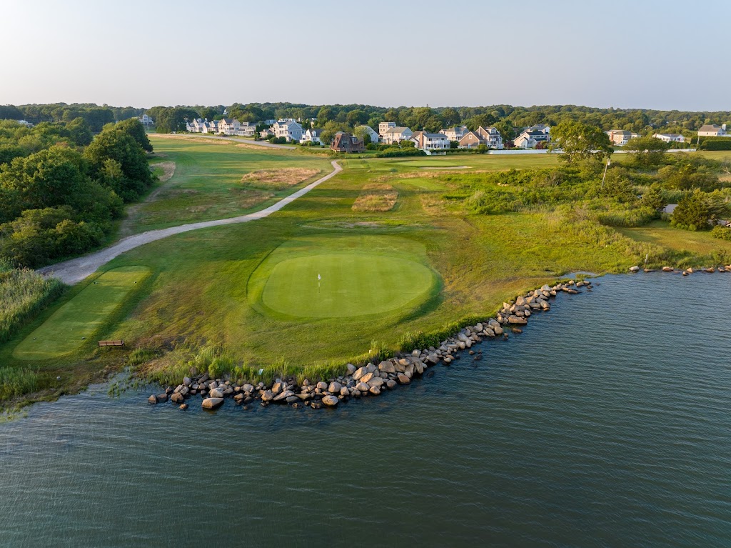 Panoramic view of a lush green golf course at Winnapaug Country Club. Smooth