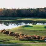 Panoramic view of a lush green golf course at Wolf Creek Golf Club. Smooth