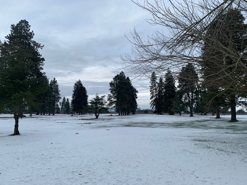 Panoramic view of a lush green golf course at Woodburn Golf Club. Smooth