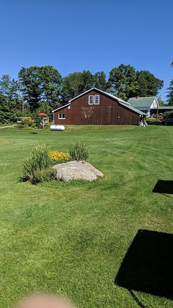 Panoramic view of a lush green golf course at Woodbury Golf Course. Smooth