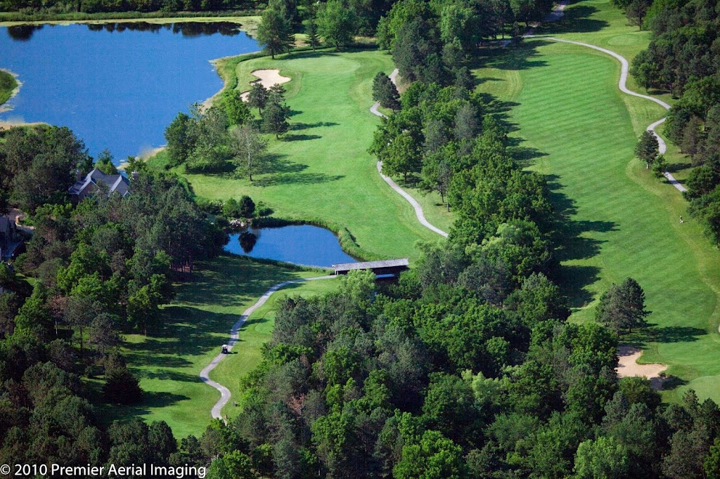 Panoramic view of a lush green golf course at Woodland Hills Golf Course. Smooth