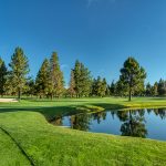 Panoramic view of a lush green golf course at Woodlands Golf Course. Smooth