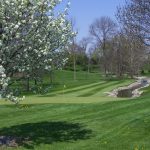 Panoramic view of a lush green golf course at Woussickett Golf Course