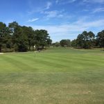 Panoramic view of a lush green golf course at Wrenwoods Golf Course. Smooth